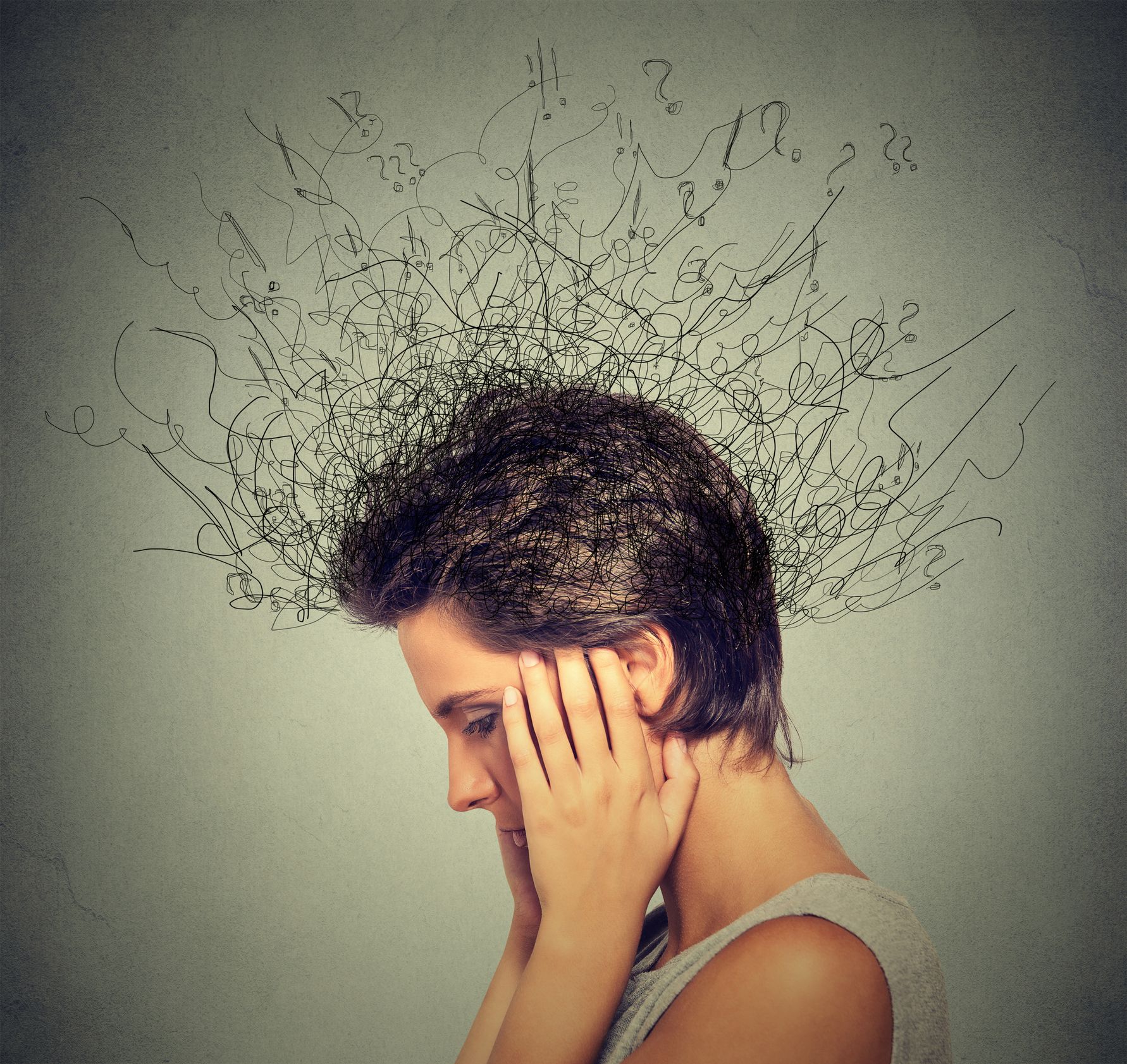 Woman with hands on head, tangled lines emerging from her head symbolizing anxiety and stress.