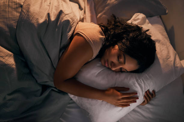 Woman sleeping peacefully, symbolizing improved sleep quality and relaxation.